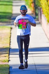 EXCLUSIVE: Shia LaBeouf heads out for a run wearing a vintage t shirt and his signature tights in his Pasadena neighborhood. After running for awhile he walked and seemed glued to something on his phone. 08 Dec 2020 Pictured: Shia LaBeouf. Photo credit: Snorlax / MEGA TheMegaAgency.com +1 888 505 6342 (Mega Agency TagID: MEGA720128_003.jpg) [Photo via Mega Agency]