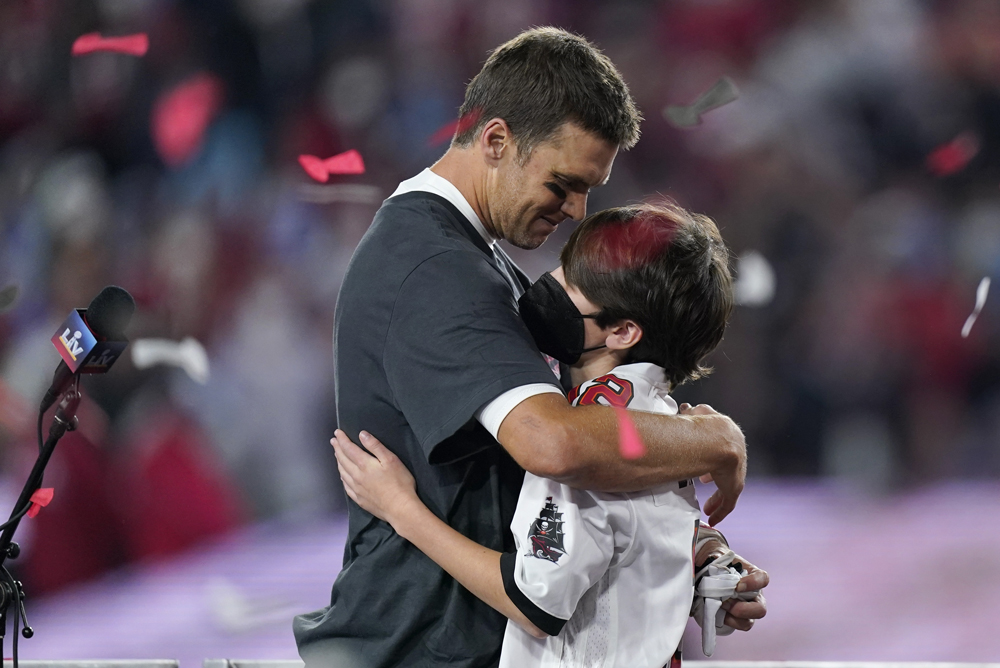Tampa Bay Buccaneers quarterback Tom Brady hugs his son after beating the Kansas City Chiefs in Sunday's NFL Super Bowl 55 football game Feb. 7, 2021, in Tampa, Fla. The Buccaneers beat the Chiefs 31-9 to win the Super Bowl. (AP Photo/Mark Humphrey)