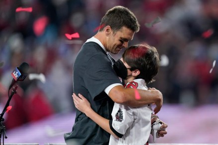 Tampa Bay Buccaneers quarterback Tom Brady embraces his son after defeating the Kansas City Chiefs in the NFL Super Bowl 55 football game Sunday, Feb. 7, 2021, in Tampa, Fla. The Buccaneers defeated the Chiefs 31-9 to win the Super Bowl. (AP Photo/Mark Humphrey)