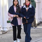 Grown up Suri Cruise can't help but smile while enjoying her neighborhood walk with a friend in NYC