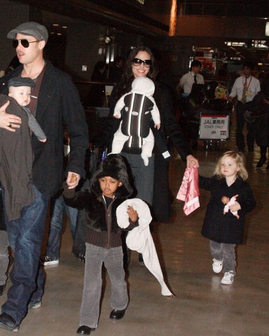 Brad Pitt with Knox Leon Jolie-Pitt and Zahara Jolie-Pitt, Angelina Jolie with Viviene Marcheline Jolie-Pitt, Shiloh Jolie-Pitt and Maddox Chivan Thornton Jolie-Pitt Brad Pitt and Angelina Jolie with family arriving at Narita International airport, Chiba, Japan - 27 Jan 2009 Brad Pitt and Angelina Jolie showed off their twins for the first time in public today after touching down at Narita International airport in Japan. When the twins, Vivienne Marcheline and Knox Leon, were born six months ago the couple sold the first pictures of the newborns to American magazine People and British magazine Hello! for $14million - with the money going to charity. Since then the Hollywood pair have kept the latest additions to their family under wraps. However, the whole brood was on show today as they walked hand in hand through the airport. Little Vivienne - named after Angelina's late mother - proved to be the spitting image of older sister Shiloh, while her twin brother Knox was dressed just like his dad in a grey jumper and flat cap. With their hands full with the twins, Brad and Angelina's older children Pax, Maddox, Shiloh and Zahara dutifully walked beside their parents. The family are in Japan to promote Pitt's new film 'The Curious Case of Benjamin Button'.