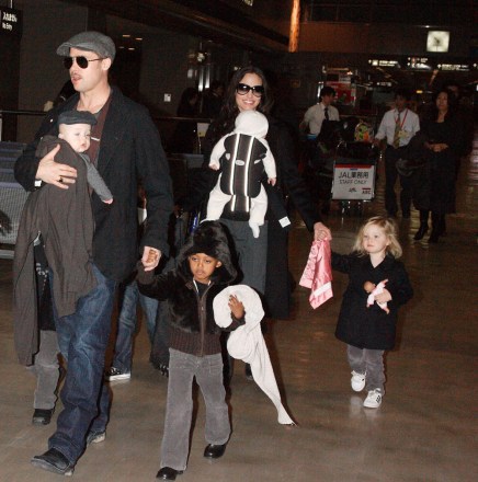 Brad Pitt with Knox Leon Jolie-Pitt and Zahara Jolie-Pitt, Angelina Jolie with Viviene Marcheline Jolie-Pitt, Shiloh Jolie-Pitt and Maddox Chivan Thornton Jolie-Pitt Brad Pitt and Angelina Jolie with family arriving at Narita International airport, Chiba, Japan - 27 Jan 2009 Brad Pitt and Angelina Jolie showed off their twins for the first time in public today after touching down at Narita International airport in Japan. When the twins, Vivienne Marcheline and Knox Leon, were born six months ago the couple sold the first pictures of the newborns to American magazine People and British magazine Hello! for $14million - with the money going to charity. Since then the Hollywood pair have kept the latest additions to their family under wraps. However, the whole brood was on show today as they walked hand in hand through the airport. Little Vivienne - named after Angelina's late mother - proved to be the spitting image of older sister Shiloh, while her twin brother Knox was dressed just like his dad in a grey jumper and flat cap. With their hands full with the twins, Brad and Angelina's older children Pax, Maddox, Shiloh and Zahara dutifully walked beside their parents. The family are in Japan to promote Pitt's new film'The Curious Case of Benjamin Button'.