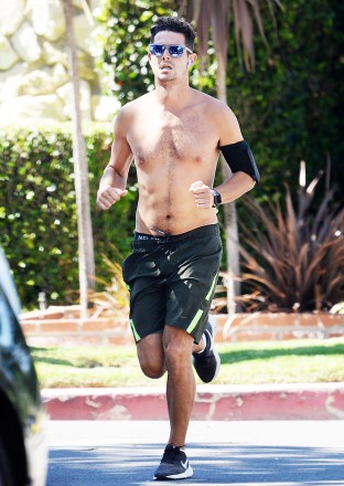 EXCLUSIVE: Wells Adams jogs shirtless and without a protective face mask in Los Angeles on Tuesday. Wells Adams and Sarah Hyland have had to postpone their engagement due to the constant coronavirus lockdown orders set forth by Governor Newsom and Mayor Eric Garretti. Garrett and Newsom recently ordered all bars, churches and other indoor business and office to close down again as well as public mask order. 14 Jul 2020 Pictured: Wells Adams jogging shirtless. Photo credit: GAC / MEGA TheMegaAgency.com +1 888 505 6342 (Mega Agency TagID: MEGA688684_001.jpg) [Photo via Mega Agency]