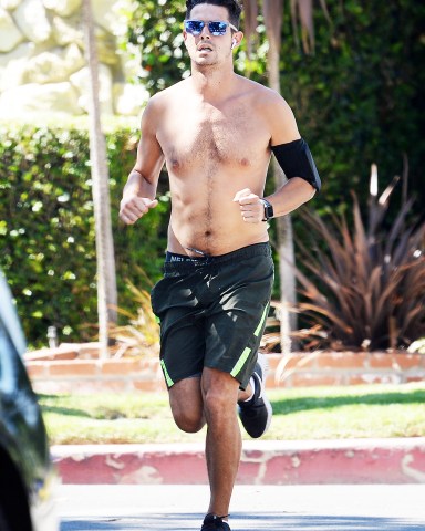 EXCLUSIVE: Wells Adams jogs shirtless and without a protective face mask in Los Angeles on Tuesday. Wells Adams and Sarah Hyland have had to postpone their engagement due to the constant coronavirus lockdown orders set forth by Governor Newsom and Mayor Eric Garretti. Garrett and Newsom recently ordered all bars, churches and other indoor business and office to close down again as well as public mask order. 14 Jul 2020 Pictured: Wells Adams jogging shirtless. Photo credit: GAC / MEGA TheMegaAgency.com +1 888 505 6342 (Mega Agency TagID: MEGA688684_001.jpg) [Photo via Mega Agency]