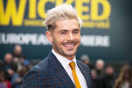 Zac Efron poses for photographers as he arrives at the 'Extremely Wicked, Shockingly Evil And Vile' premiere in London