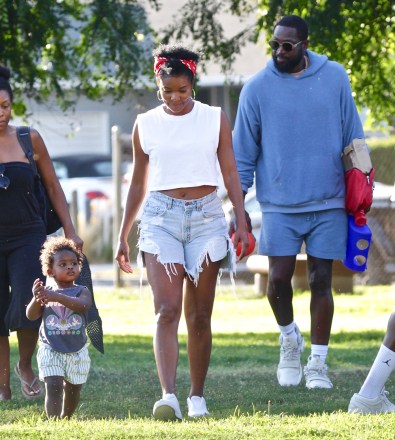 EXCLUSIVE: NBA superstar Dwyane Wade and Gabrielle Union spend the day at the park with daughters Zaya and Kaavia. The family spent the day at a Los Angeles park where they played horseshoes and baseball. Zaya hit a homer at one point and were later seen celebrating. Gabrielle Union also was seen with noticeably shorter hair for the outing. **SPECIAL INSTRUCTIONS*** Please pixelate children's faces before publication.***. 11 Jul 2020 Pictured: NBA superstar Dwyane Wade and Gabrielle Union spend the day at the park with daughters Zaya and Kaavia. Photo credit: ROMA / MEGA TheMegaAgency.com +1 888 505 6342 (Mega Agency TagID: MEGA688003_001.jpg) [Photo via Mega Agency]