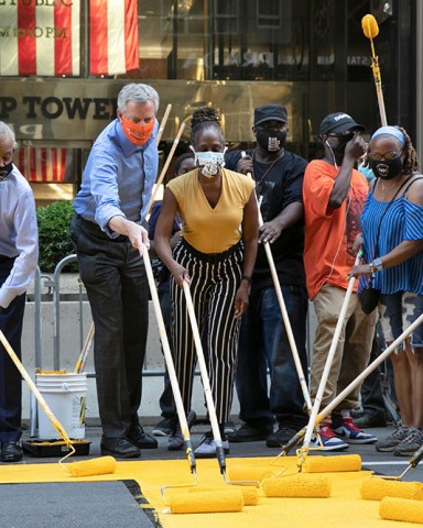 Mayor Bill de Blasio, third from left, participates in painting Black Lives Matter on Fifth Avenue in front of Trump Tower, in New York. The mayor's wife, Chirlane McCray, is fourth from left and Rev. Al Sharpton is second from left
Racial Injustice , New York, United States - 09 Jul 2020