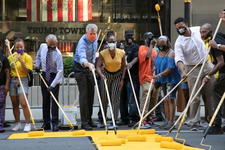 Mayor Bill de Blasio, third from left, participates in painting Black Lives Matter on Fifth Avenue in front of Trump Tower, in New York. The mayor's wife, Chirlane McCray, is fourth from left and Rev. Al Sharpton is second from left
Racial Injustice , New York, United States - 09 Jul 2020