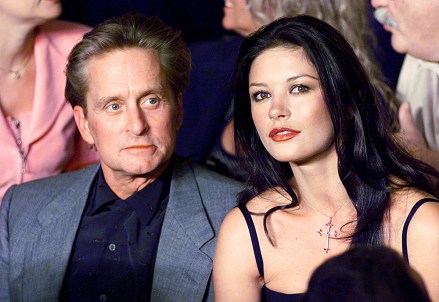 Actors Michael Douglas and Catherine Zeta Jones sit together at ringside before the start of the WBC/IBF Welterweight Championship fight between Oscar De La Hoya and Felix Trinidad at the Mandalay Bay Events Center in Las Vegas Saturday, Sept. 18, 1999. (AP Photo/Kevork Djansezian)