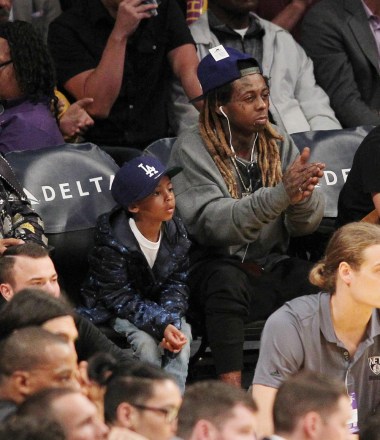 Lil Wayne at the Lakers game with his son. The Los Angeles Lakers defeated the Brooklyn Nets by the final score of 125-118 at Staples Center in downton Los Angeles.Featuring: Lil Wayne, sonWhere: Los Angeles, California, United StatesWhen: 15 Nov 2016Credit: WENN.com Newscom/(Mega Agency TagID: wennphotossix066212.jpg) [Photo via Mega Agency]