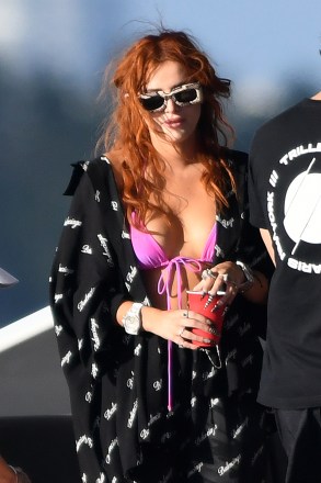 Actress Bella Thorne wears a pink bikini holding a plastic bag with suspicious contents cruising on a yacht with her mother in Miami. 11 Mar 2021 Pictured: Bella Thorne; Tamara Thorne. Photo credit: MEGA TheMegaAgency.com +1 888 505 6342 (Mega Agency TagID: MEGA738924_010.jpg) [Photo via Mega Agency]