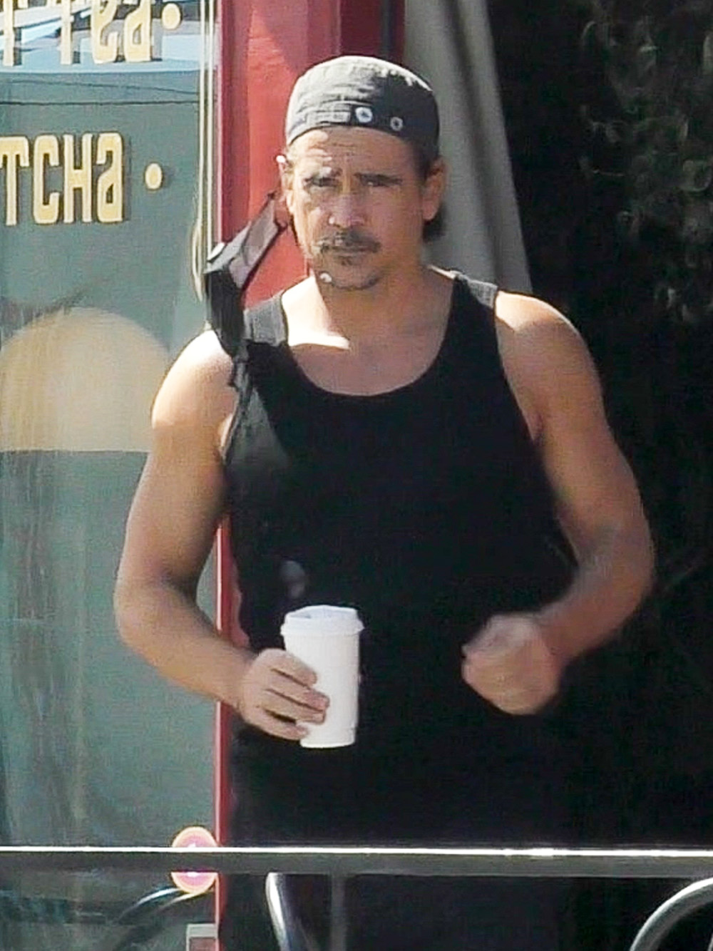 Colin Farrell enjoys his coffee on the go batman