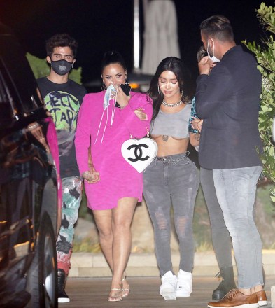 Demi Lovato is all smiles as she and Max Ehrich and best friend Nikita Dragun dine at Nobu Malibu in Malibu. The 27 year old singer who recently got engaged is wearing a pink dress and carrying a Chanel purse in hand. 07 Aug 2020 Pictured: Demi Lovato, Max Ehrich and Nikita Dragun. Photo credit: Photographer Group/MEGA TheMegaAgency.com +1 888 505 6342 (Mega Agency TagID: MEGA693208_001.jpg) [Photo via Mega Agency]