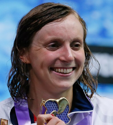 Katie Ledecky of the U.S., poses with her medal on the podium after winning the women's 1500m freestyle timed final during the Pan Pacific swimming championships in Tokyo, Sunday, Aug.12, 2018.(AP Photo/Koji Sasahara)