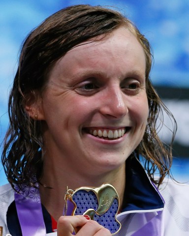 Katie Ledecky of the U.S., poses with her medal on the podium after winning the women's 1500m freestyle timed final during the Pan Pacific swimming championships in Tokyo, Sunday, Aug.12, 2018.(AP Photo/Koji Sasahara)