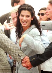 American actress Sandra Bullock is protected by bodyguards after posing for photographers on the beachfront in Cannes, French Riviera, Wednesday May 15, 1996. Bullock and her British director Richard Attenborough are in Cannes to promote their movie "In love and war" during the 49th International Film Festival.(AP PHOTO/Laurent Rebours)