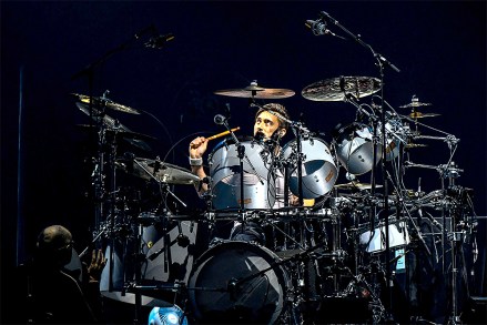 Singer Phil Collins leads Genesis as they play in their "The Last Domino?" tour at the United Center, in Chicago. On drums in background is Collins' son Nicholas Collins
Genesis Last Domino? Tour, Chicago, United States - 15 Nov 2021