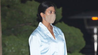 New mom Kourtney Kardashian hides her face with her Prada bag