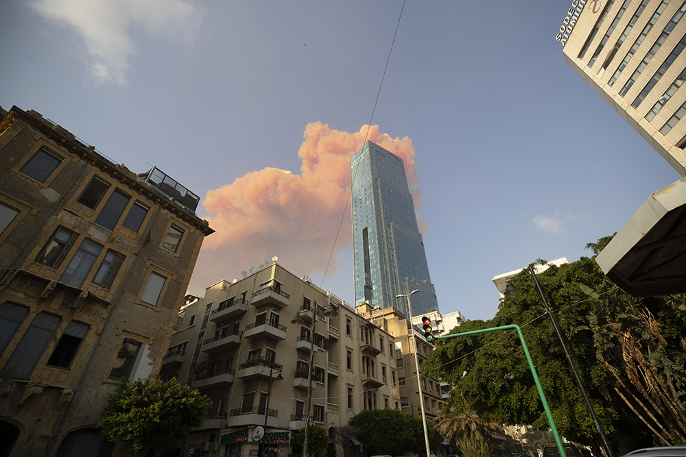 A cloud from a massive explosion is seen in in Beirut, Lebanon, Tuesday, Aug. 4, 2020. Massive explosions rocked downtown Beirut on Tuesday, flattening much of the port, damaging buildings and blowing out windows and doors as a giant mushroom cloud rose above the capital. Witnesses saw many people injured by flying glass and debris. (AP Photo/Hassan Ammar)