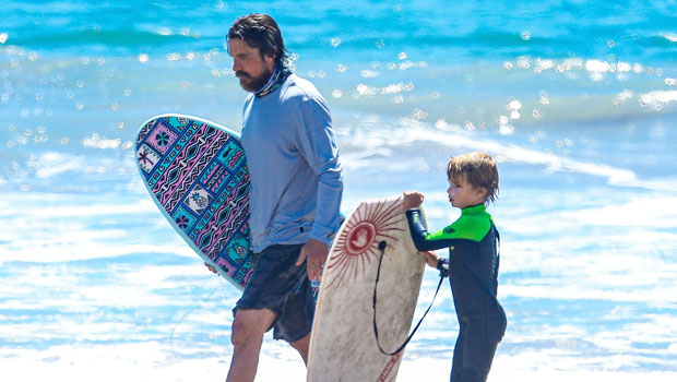 Christian Bale smiles watching son Joseph bodyboard and takes