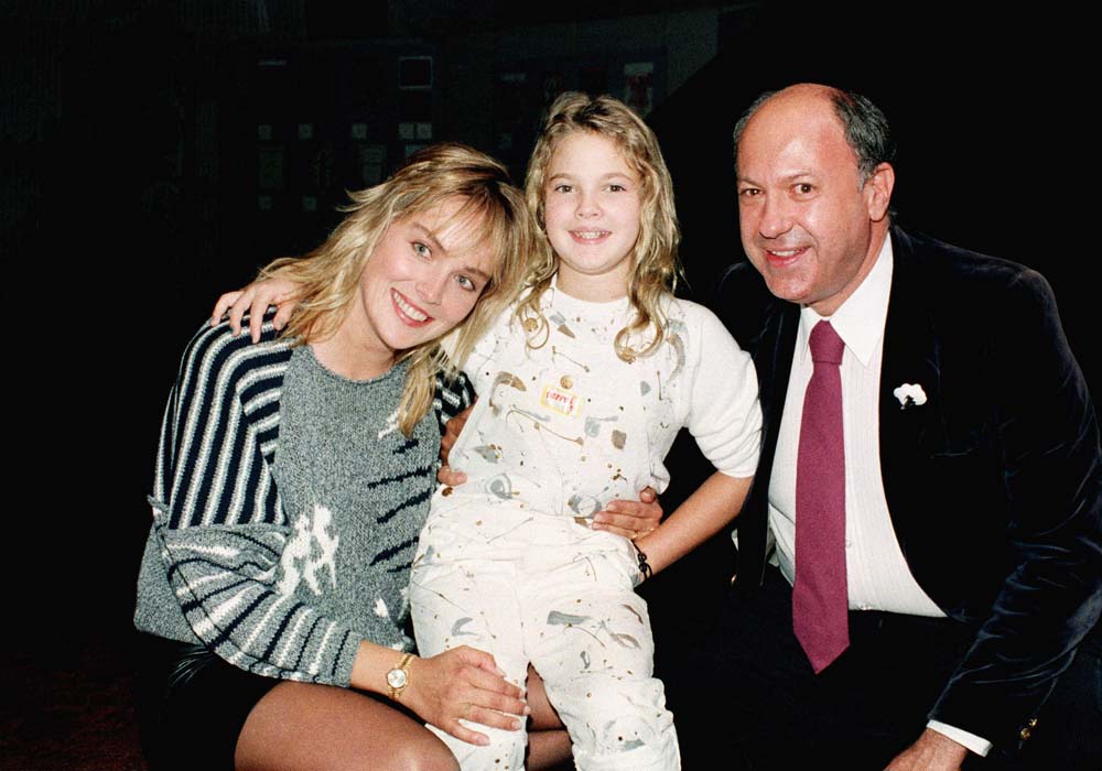 Actress Drew Barrymore, center, with Sharon Stone, at left, and Allen Garfield at Hollywood screening of "Irreconcilable Differences" on September 24, 1984.    (AP Photo/Scott Harms)