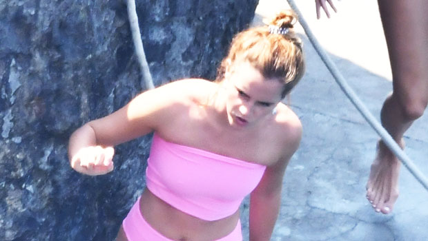 Emma Watson looked magical while rocking a neon pink bikini during a trip t...