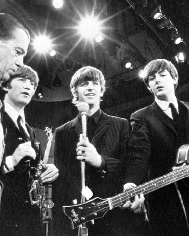 American TV host Ed Sullivan, left, talks with three members of the British pop group The Beatles during a rehearsal for their appearance on his TV show, in New York, Feb. 8, 1964. From left, Sullivan, John Lennon, Ringo Starr and Paul McCartney. George Harrison, the fourth member of the group missed the rehearsal due to illness. (AP Photo)