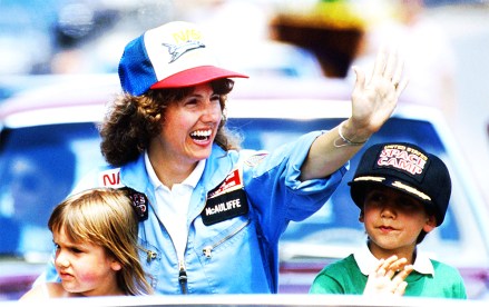 FILE - In this 1985 file photo, high school teacher Christa McAuliffe rides with her children Caroline, left, and Scott during a parade down Main Street in Concord, N.H. New Hampshire Gov. Chris Sununu is proclaiming a day in honor of McAuliffe who died in the NASA Challenger disaster decades ago. Sununu said Sunday, Jan. 28 will be known as "Christa McAuliffe Day" in honor of the woman selected to become the first educator in space. (AP Photo/Jim Cole, File)
