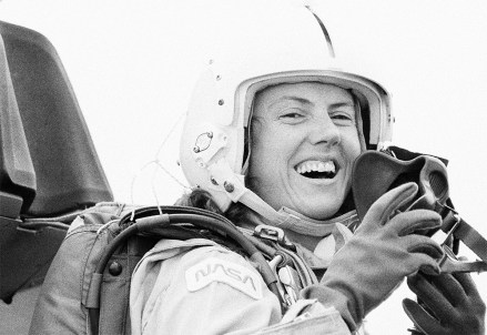 Christa McAuliffe, the space teacher from Concord, New Hampshire, helmeted and ready for the oxygen mask as she prepared for an orientation flight aboard one of the T-28 NASA training planes, Monday, Sept. 30, 1985 in Houston, Texas. Pilot of the jet was the commander for the January flight, Dick Scobee. (AP Photo/Ed Kolenovsky)