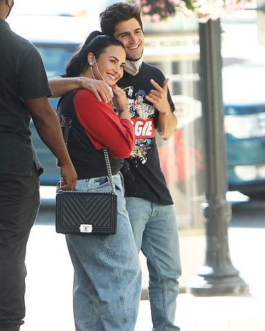 Demi Lovato and her new fiance Max Ehrich look happy in love on Beverly Hills shopping trip. The lovebirds were spotted out and about on Monday afternoon (july 27). Singer Demi was showing off her incredible engagement ring, after her beau popped the question last week during a romantic proposal on a Malibu beach. The loved-up duo couldn't keep their hands off each other, as they cuddled on famous Rodeo Drive and seemed happy to be spotted by photographers. The hit Versace and Persol stores and enjoyed a late lunch at 208 Rodeo Dr, an upscale restaurant with bistro fare & California cuisine.Pictured: Demi Lovato,Max EhrichRef: SPL5179046 280720 NON-EXCLUSIVEPicture by: SplashNews.comSplash News and PicturesUSA: +1 310-525-5808London: +44 (0)20 8126 1009Berlin: +49 175 3764 166photodesk@splashnews.comWorld Rights