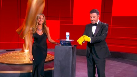 Jennifer Aniston, left, and Jimmy Kimmel sanitize the winner's envelope during the 72nd Emmy Awards telecast on Sunday, Sept. 20, 2020 at 8:00 PM EDT/5:00 PM PDT on ABC. (Invision for the Television Academy/AP)
