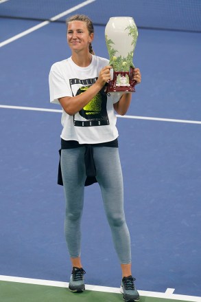 Victoria Azarenka, of Belarus, holds the winners trophy as she celebrates winning the Western & Southern Open tennis tournament during a trophy ceremony Saturday, Aug. 29, 2020, in New York.Azarenka won the tournament after her finals opponent, Naomi Osaka, of Japan, withdrew because of a hamstring injury. (AP Photo/Frank Franklin II)