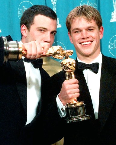 FILE - In this March 23, 1998 file photo, Ben Affleck, left, and Matt Damon display their Oscars for Best Original Screenplay for "Good Will Hunting,"at the 70th Academy Awards at the Shrine Auditorium in Los Angeles. (AP Photo/Reed Saxon, file)