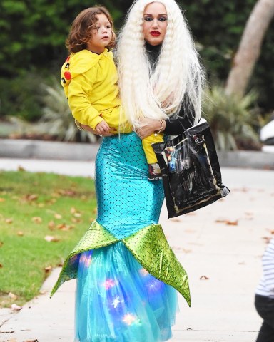 Los Angeles, CA  - *EXCLUSIVE*  - Singer and TV host Gwen Stefani dressed as a mermaid for Halloween and revealed a distinct stomach bump in her tight outfit. Her father also joined her to help her with her children. Apollo was dressed as Pikachu and Zuma was dressed as an even larger, inflatable Pikachu while Kingston sported a more classic Halloween look. Shot on 11/01/17  Pictured: Gwen Stefani, Apollo Rossdale  BACKGRID USA 1 NOVEMBER 2017   USA: +1 310 798 9111 / usasales@backgrid.com  UK: +44 208 344 2007 / uksales@backgrid.com  *UK Clients - Pictures Containing Children Please Pixelate Face Prior To Publication*