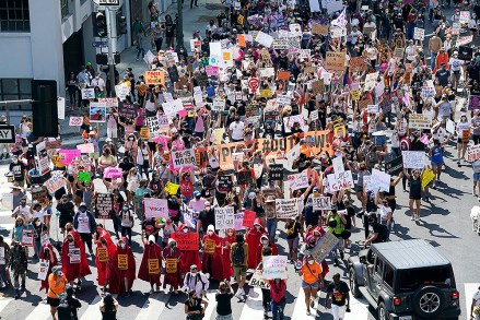 Demonstrators march during a Women's March Saturday, Oct. 17, 2020, in Los Angeles. Thousands of women rallied in U.S. cities, to oppose President Donald Trump and his fellow Republican candidates in the Nov. 3 elections. (AP Photo/Marcio Jose Sanchez)