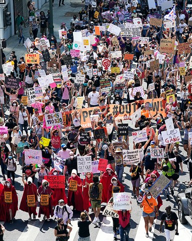 Demonstrators march during a Women's March Saturday, Oct. 17, 2020, in Los Angeles. Thousands of women rallied in U.S. cities, to oppose President Donald Trump and his fellow Republican candidates in the Nov. 3 elections. (AP Photo/Marcio Jose Sanchez)