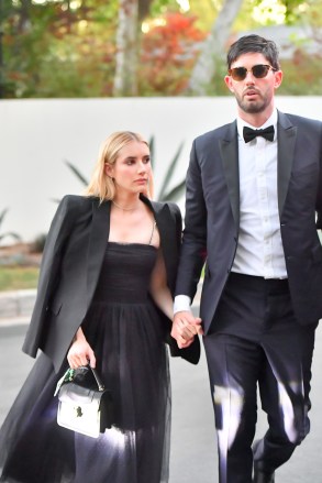 Emma Roberts spotted arriving at Paris Hilton‚Äôs lavish wedding holding hands with Britney Spears' longtime agent Cade Hudson. Amid a flurry of celebrity guests, the actress looked stunning with her handsome companion as they showed up to the extravagant sunset nuptials in Bel Air Thursday evening. She wore a trendy oversized blazer over a whimsical black tulle dress as she strode hand in hand with her suitor. The 30-year-old blonde has been in a relationship with actor Garrett Hedlund since 2019 and the pair welcomed son Rhodes last December. It appears they are not following each other on Instagram, and celeb gossip site Deux Moi also sparked a breakup rumor about the couple recently. Meanwhile, more celeb guests arrived to the plush affair including Paula Abdul, Rachel Zoe, Ashley Benson, Steve Wynn, Elliott Mintz and Kyle Richards. Paris Hilton is set to tie the knot with Carer Reum after two years of dating.Pictured: Emma Roberts,Cade HudsonRef: SPL5274322 121121 NON-EXCLUSIVEPicture by: SplashNews.comSplash News and PicturesUSA: +1 310-525-5808London: +44 (0)20 8126 1009Berlin: +49 175 3764 166photodesk@splashnews.comWorld Rights