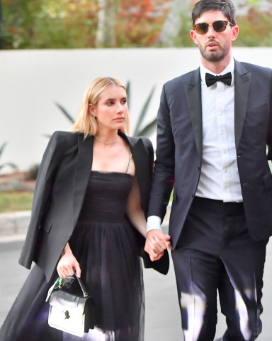 Emma Roberts spotted arriving at Paris Hilton‚Äôs lavish wedding holding hands with Britney Spears' longtime agent Cade Hudson. Amid a flurry of celebrity guests, the actress looked stunning with her handsome companion as they showed up to the extravagant sunset nuptials in Bel Air Thursday evening. She wore a trendy oversized blazer over a whimsical black tulle dress as she strode hand in hand with her suitor. The 30-year-old blonde has been in a relationship with actor Garrett Hedlund since 2019 and the pair welcomed son Rhodes last December. It appears they are not following each other on Instagram, and celeb gossip site Deux Moi also sparked a breakup rumor about the couple recently. Meanwhile, more celeb guests arrived to the plush affair including Paula Abdul, Rachel Zoe, Ashley Benson, Steve Wynn, Elliott Mintz and Kyle Richards. Paris Hilton is set to tie the knot with Carer Reum after two years of dating.  Pictured: Emma Roberts,Cade Hudson Ref: SPL5274322 121121 NON-EXCLUSIVE Picture by: SplashNews.com  Splash News and Pictures USA: +1 310-525-5808 London: +44 (0)20 8126 1009 Berlin: +49 175 3764 166 photodesk@splashnews.com  World Rights