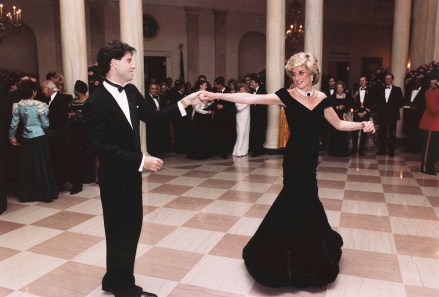 FILE - In this Nov. 9, 1985 photo provided by the Ronald Reagan Library, actor John Travolta dances with Princess Diana at a White House dinner in Washington. This outfit is featured in an exhibition of 25 dresses and outfits worn by Diana entitled "Diana: Her Fashion Story" at Kensington Palace in London, opening on Friday, Feb. 24, 2017. (Ronald Reagan Library via AP, File)
