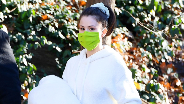 selena gomez keeps it cozy in black sweats and prada sneakers as