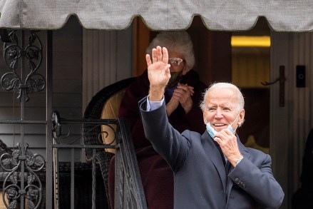 Democratic presidential candidate, former Vice President Joe Biden, waves from the front steps of his childhood home, during an early visit on Election Day, Tuesday, Nov. 3, 2020, in Scranton, Pa. (Jose F. Moreno/The Philadelphia Inquirer via AP)