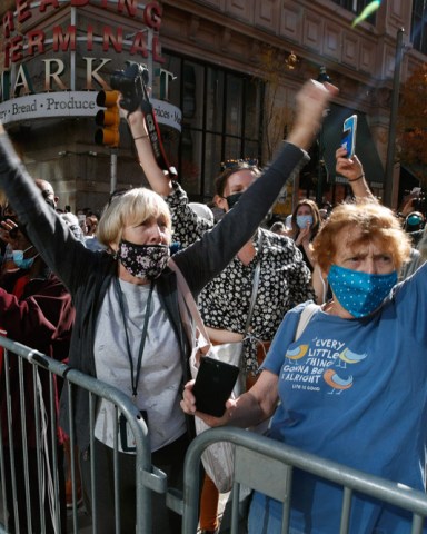 People celebrate outside the Pennsylvania Convention Center, Saturday, Nov. 7, 2020, in Philadelphia, after Democrat Joe Biden defeated President Donald Trump to become 46th president of the United States. (AP Photo/Rebecca Blackwell)