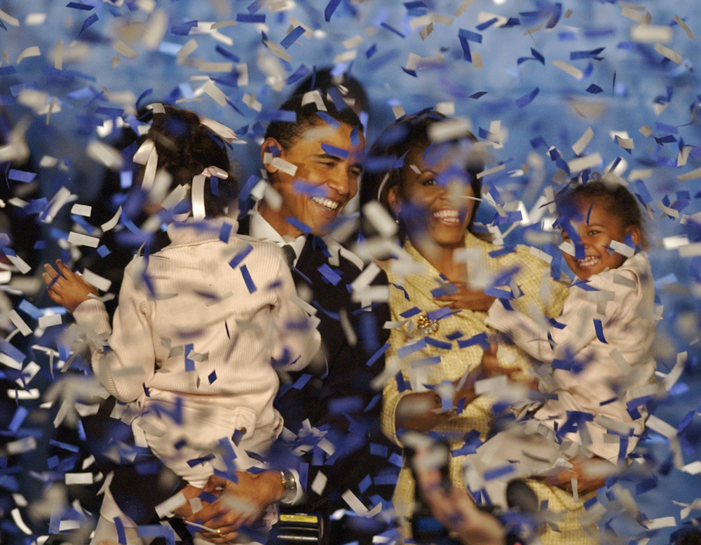 ** ADVANCE FORTHURSDAY, JAN. 15 AND THEREAFTER -- FILE ** In this. Nov. 2, 2004 file photo, Illinois Senator-elect Barack Obama, holds his daughter Malia, and his wife Michelle, holds their daughter Sasha, and are covered in confetti after Obama delivered his acceptance speech in Chicago.  Obama was only the fifth black U.S. Senator to be elected in history. (AP Photo/M. Spencer Green, File)