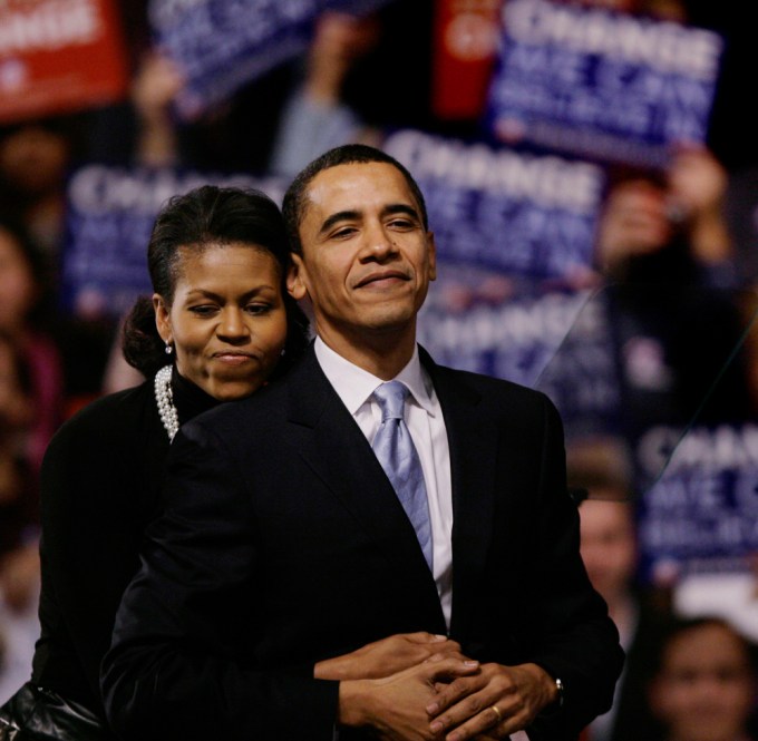 Barack Obama gets a supportive hug from his wife Michelle
