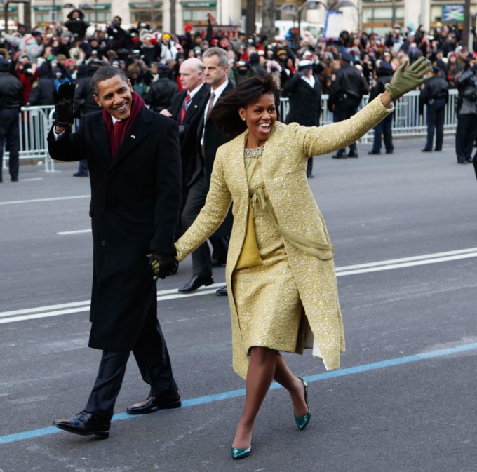 Barack and Michelle Obama hold hands along his inaugural parade route