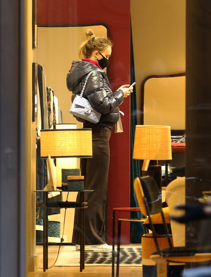 Lily-Rose Depp Checks Out Her Phone While Shopping