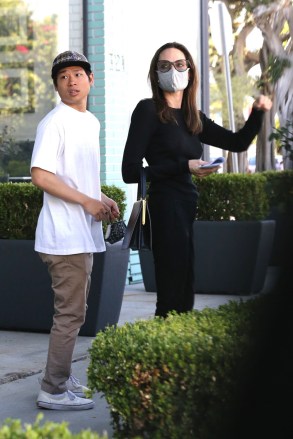 West Hollywood, CA  - *EXCLUSIVE*  - Angelina Jolie keeps her classy look wearing all black carrying a black leather designer tote while furniture shopping at high-end Knoll Home Design Shop with her 17-year-old son Pax.Pictured: Angelina Jolie, Pax Thien Jolie-PittBACKGRID USA 3 JULY 2021 USA: +1 310 798 9111 / usasales@backgrid.comUK: +44 208 344 2007 / uksales@backgrid.com*UK Clients - Pictures Containing ChildrenPlease Pixelate Face Prior To Publication*