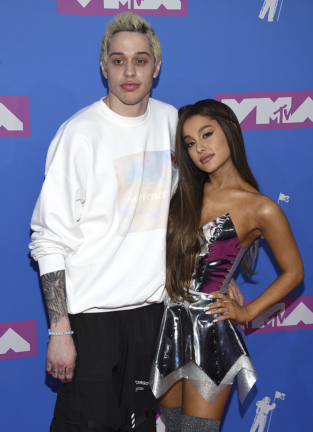 FILE- In this Aug. 20, 2018, file photo Pete Davidson, left, and Ariana Grande arrive at the MTV Video Music Awards at Radio City Music Hall in New York. Grande has released a song referencing her exes, including former fiance and “SNL” star Davidson and the late Mac Miller. (Photo by Evan Agostini/Invision/AP, File)