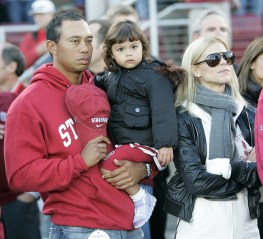 Tiger Woods, daughter Sam Woods and wife Elin Nordegren, before a NCAA college football game in Stanford, Calif., Saturday, Nov. 21, 2009.(AP Photo/Marcio Jose Sanchez)