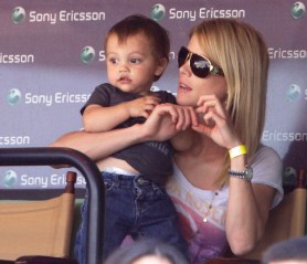 Elin Nordegren, the wife of Tiger Woods, sits with her son Charlie during a semifinal match between Rafael Nadal and Andy Roddick at the Sony Ericsson Open tennis tournament in Key Biscayne, Fla. Friday, April 2, 2010. (AP Photo/Lynne Sladky)